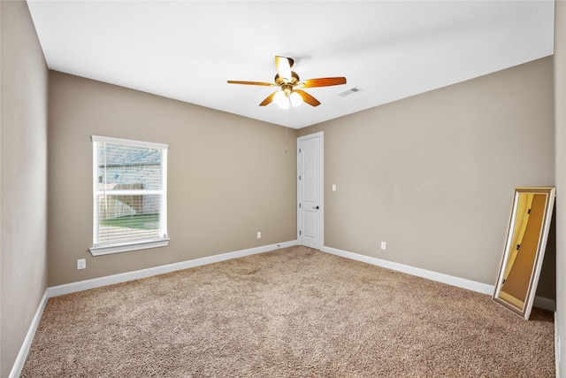 empty room featuring carpet floors and ceiling fan