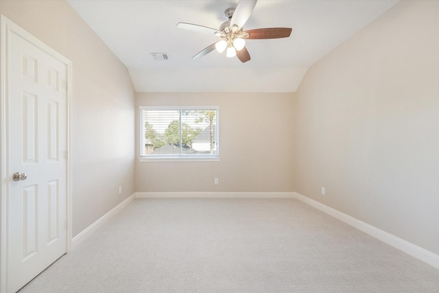 carpeted empty room featuring ceiling fan and lofted ceiling