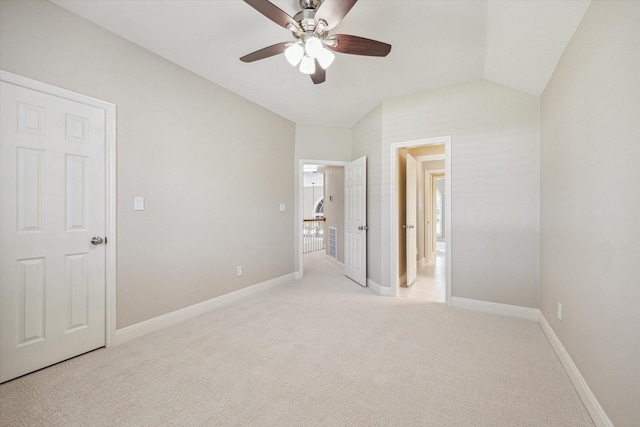 unfurnished bedroom with ceiling fan, light colored carpet, and lofted ceiling