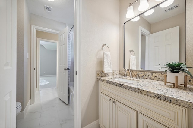 bathroom with toilet and vanity