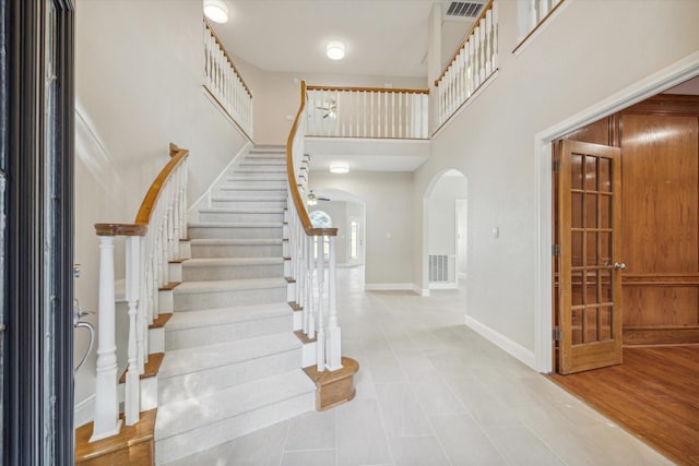 entryway with a high ceiling and light tile patterned floors