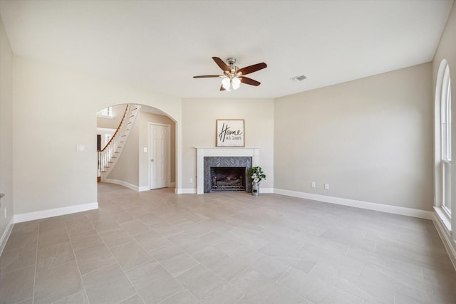 unfurnished living room with ceiling fan and light tile patterned flooring