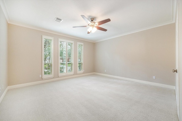 carpeted empty room featuring ceiling fan and crown molding