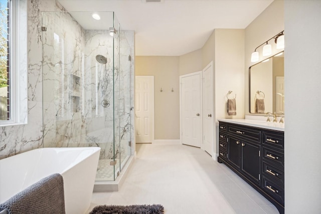 bathroom featuring plus walk in shower, tile patterned floors, and vanity