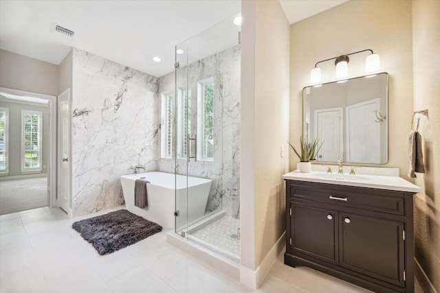 bathroom featuring tile walls, vanity, and shower with separate bathtub