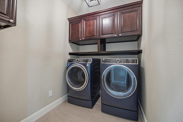 washroom with light tile patterned flooring, cabinets, and independent washer and dryer