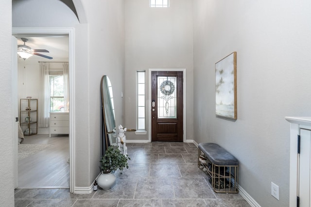 entrance foyer featuring ceiling fan and a healthy amount of sunlight