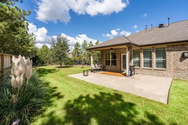 back of property featuring a yard and a patio area