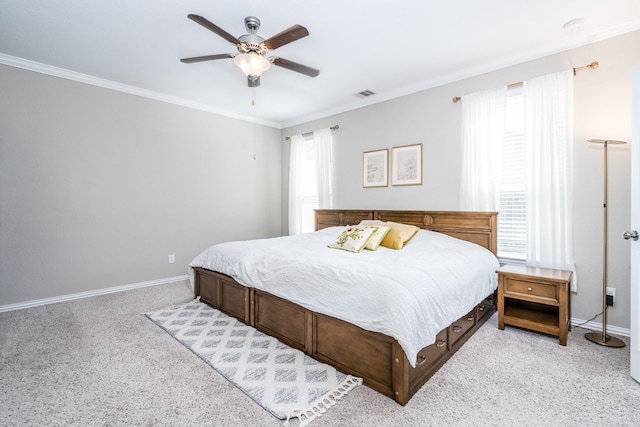 bedroom featuring ceiling fan, crown molding, and light colored carpet