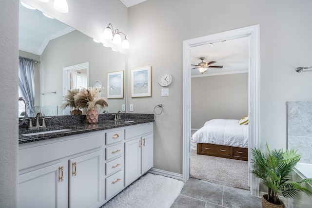 bathroom featuring vanity, ceiling fan, ornamental molding, and vaulted ceiling