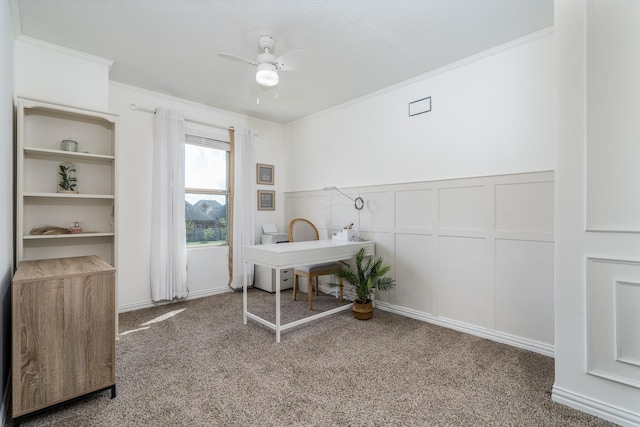 carpeted office featuring ceiling fan and crown molding