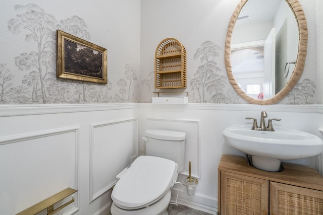 bathroom featuring vanity and toilet