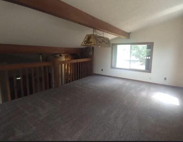 unfurnished living room featuring carpet and vaulted ceiling with beams