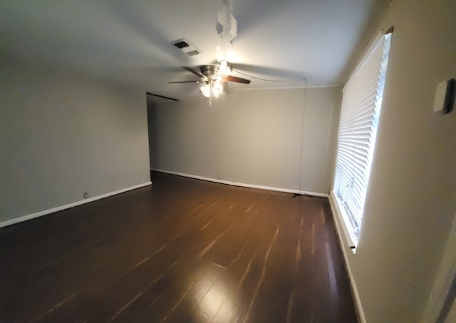 unfurnished room featuring dark hardwood / wood-style floors and ceiling fan