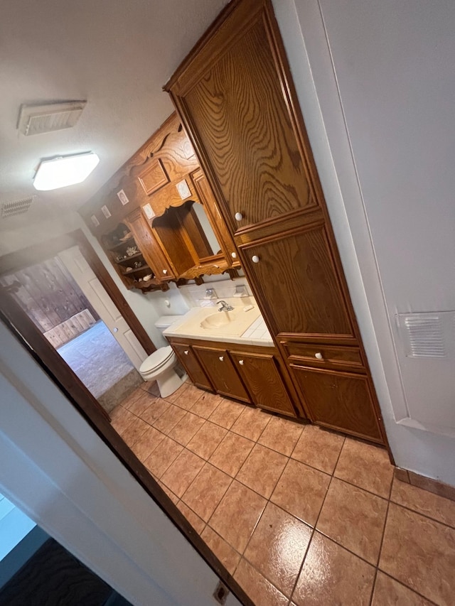 bathroom featuring sink, tile patterned flooring, and toilet