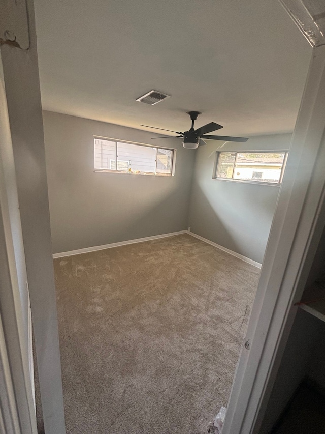 empty room with carpet flooring and ceiling fan