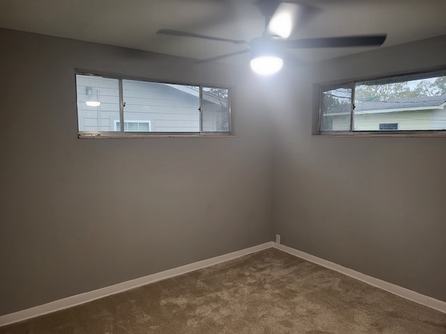 carpeted empty room featuring ceiling fan