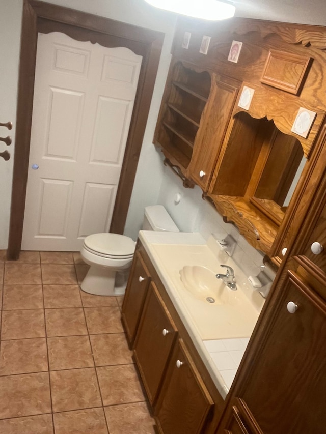 bathroom featuring tile patterned floors, vanity, and toilet