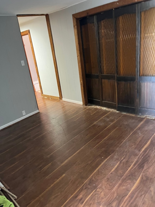 empty room featuring dark hardwood / wood-style flooring