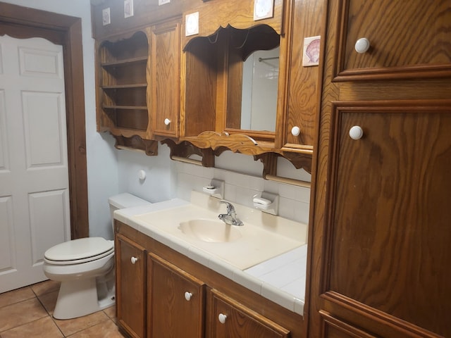 bathroom with tile patterned flooring, vanity, and toilet