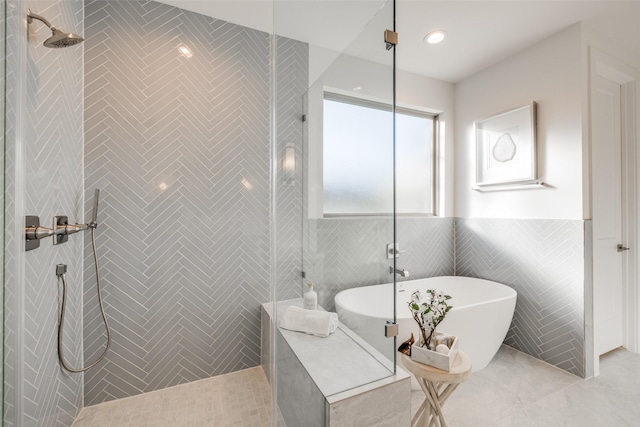 bathroom with independent shower and bath and tile walls