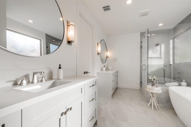 bathroom with vanity and separate shower and tub