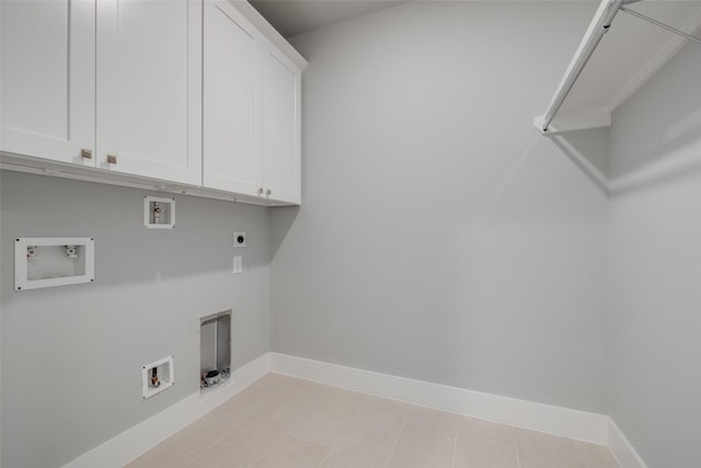 laundry room with hookup for an electric dryer, washer hookup, cabinets, gas dryer hookup, and light tile patterned floors