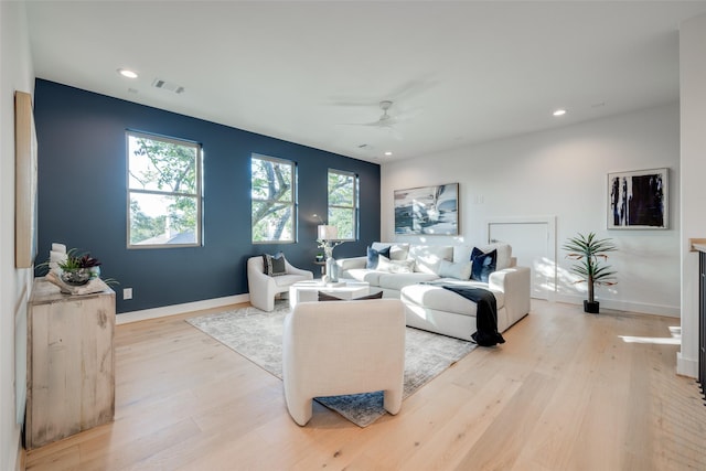 living room featuring ceiling fan and light hardwood / wood-style flooring