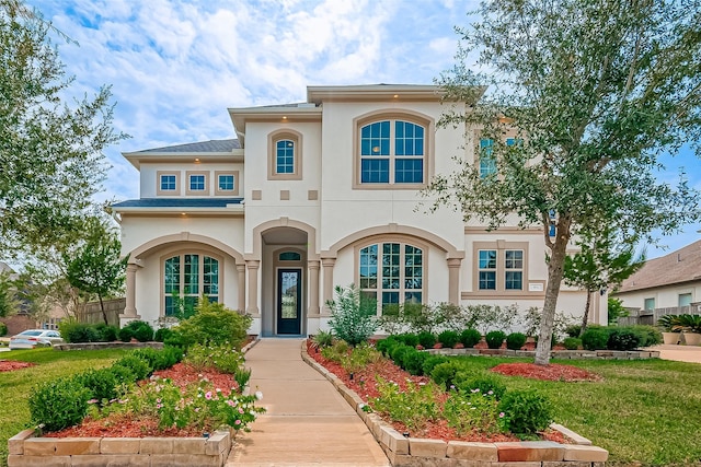 mediterranean / spanish house with a front lawn