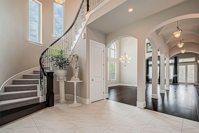 foyer entrance with french doors and a chandelier