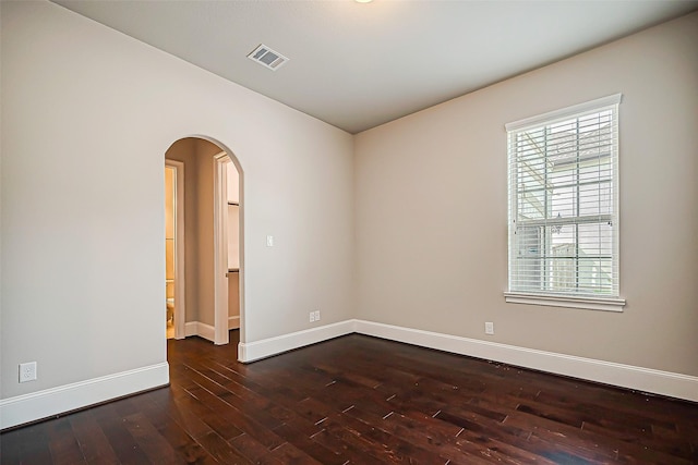 spare room with dark wood-type flooring