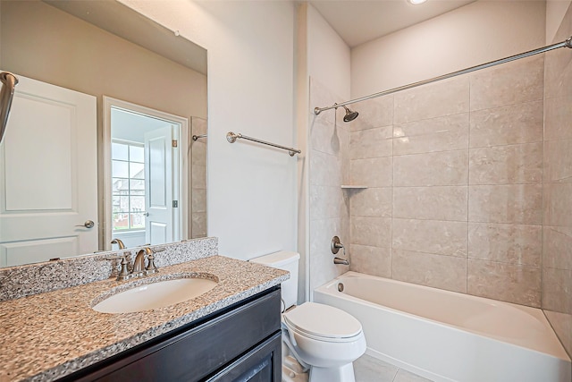 full bathroom featuring vanity, tile patterned floors, tiled shower / bath combo, and toilet