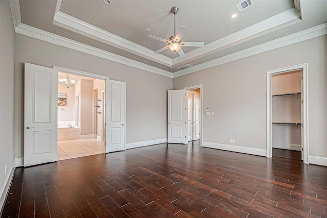 unfurnished bedroom featuring ceiling fan with notable chandelier, dark hardwood / wood-style floors, a raised ceiling, and crown molding