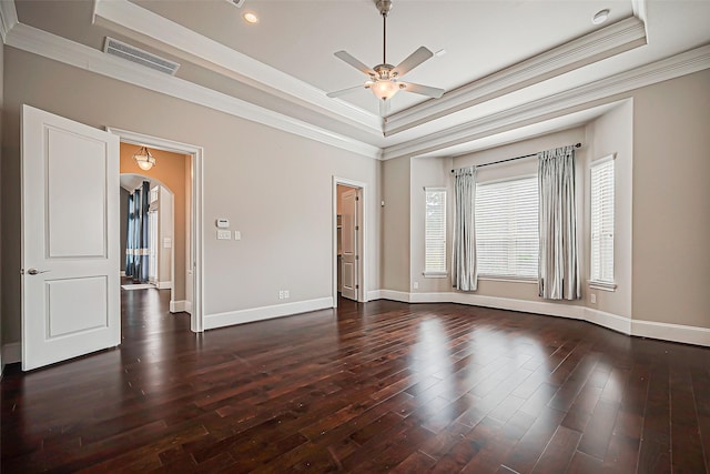 spare room with ceiling fan, a raised ceiling, and crown molding