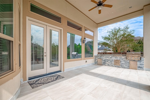 view of patio with an outdoor kitchen, ceiling fan, french doors, and a grill