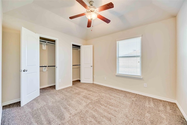 unfurnished bedroom featuring light colored carpet and ceiling fan