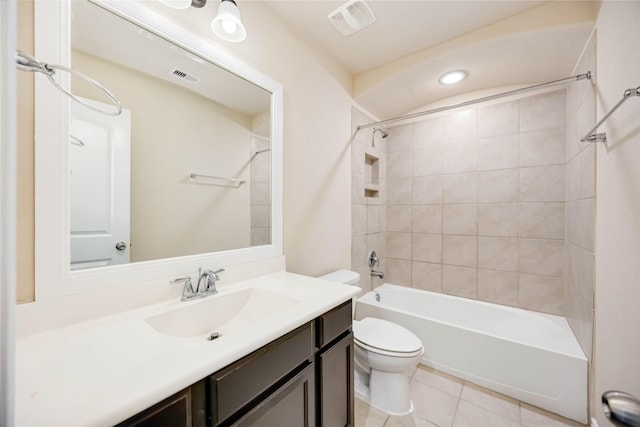 full bathroom featuring toilet, vanity, tile patterned floors, and tiled shower / bath