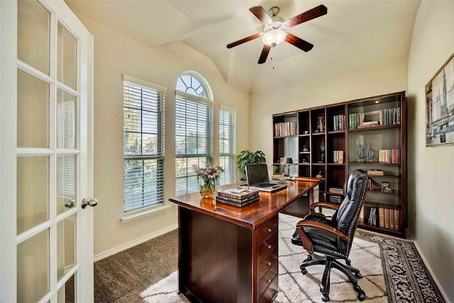 office space with ceiling fan, lofted ceiling, and light carpet