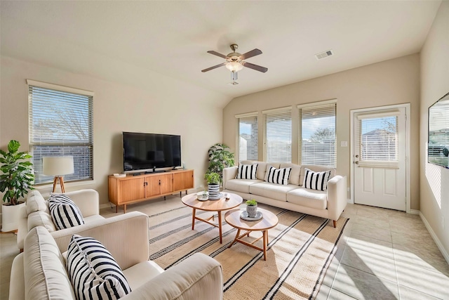 living room featuring ceiling fan, light tile patterned floors, and lofted ceiling