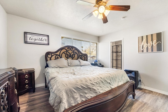 bedroom featuring hardwood / wood-style floors and ceiling fan