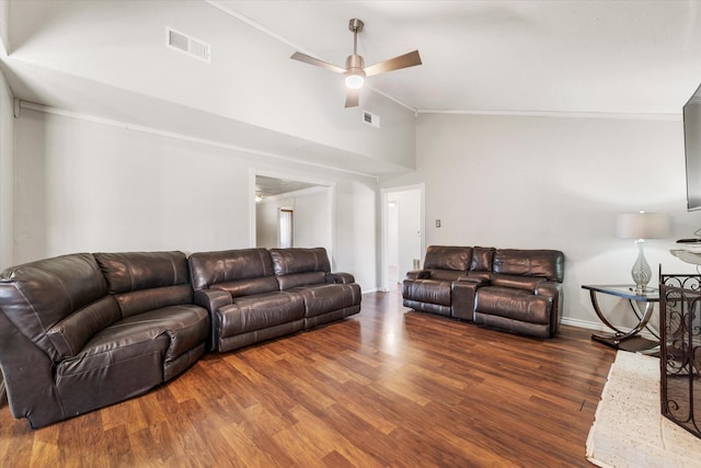 living room with ceiling fan, dark hardwood / wood-style flooring, ornamental molding, and vaulted ceiling