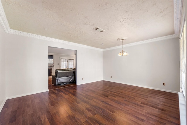 unfurnished room with a textured ceiling, crown molding, and dark wood-type flooring