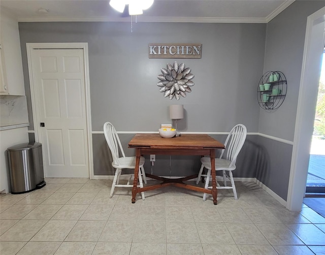 dining room with ceiling fan, light tile patterned floors, and crown molding