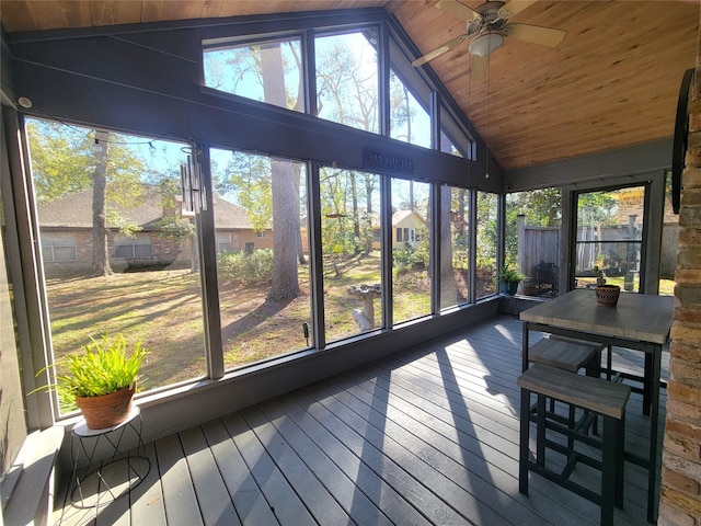 unfurnished sunroom with ceiling fan, wooden ceiling, and vaulted ceiling