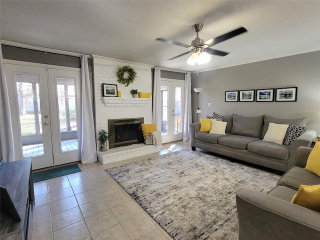 living room featuring plenty of natural light, ceiling fan, light tile patterned floors, and french doors