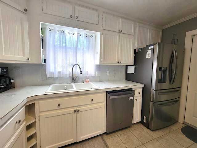 kitchen featuring appliances with stainless steel finishes, backsplash, light tile patterned floors, and sink