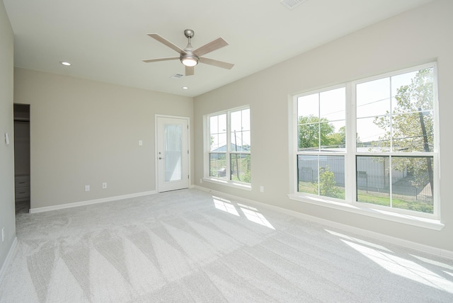 spare room featuring ceiling fan and light colored carpet