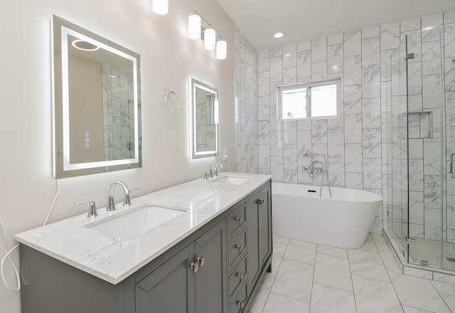 bathroom featuring shower with separate bathtub and vanity