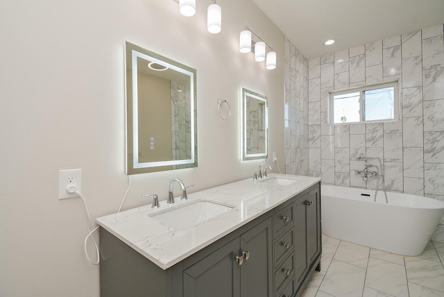 bathroom featuring vanity and a bath