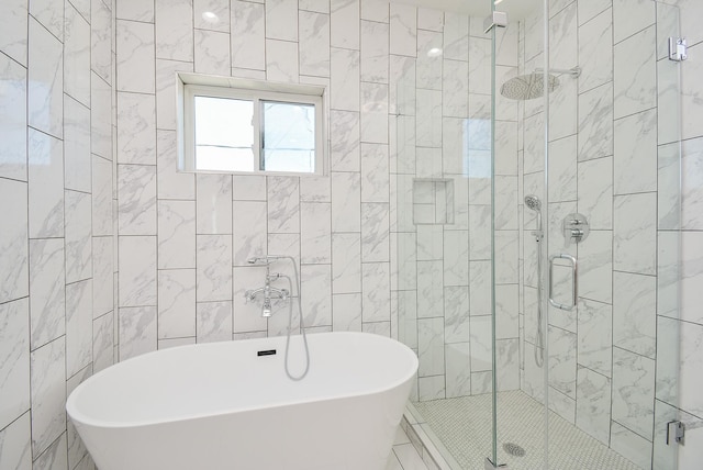 bathroom with tile walls and independent shower and bath